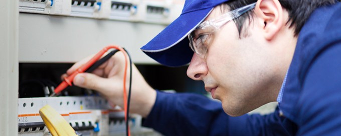 A young man doing technician work